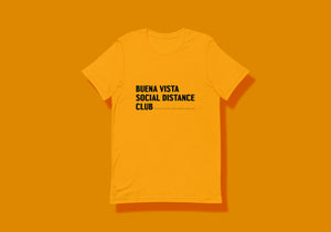 Golden yellow t-shirt reads in black "Buena Vista Social Distance Club" in a chunky font with ruler ticks after word "Club" to signify six feet