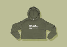 Load image into Gallery viewer, Cropped army green hoodie reads &quot;Buena Vista Social Distance Club&quot; in all caps white lettering with ruler tick mark design