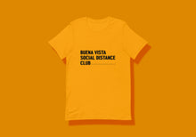 Load image into Gallery viewer, Golden yellow t-shirt reads in black &quot;Buena Vista Social Distance Club&quot; in a chunky font with ruler ticks after word &quot;Club&quot; to signify six feet