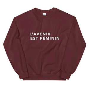 Maroon jumper reads 'L'Avenir Est Feminin' in Futura
